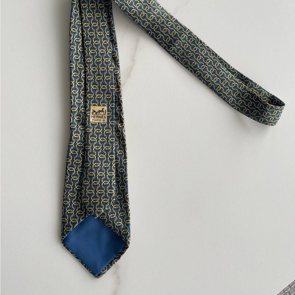 Hermès La Maison Blue and Gold Tie…Sold as is.